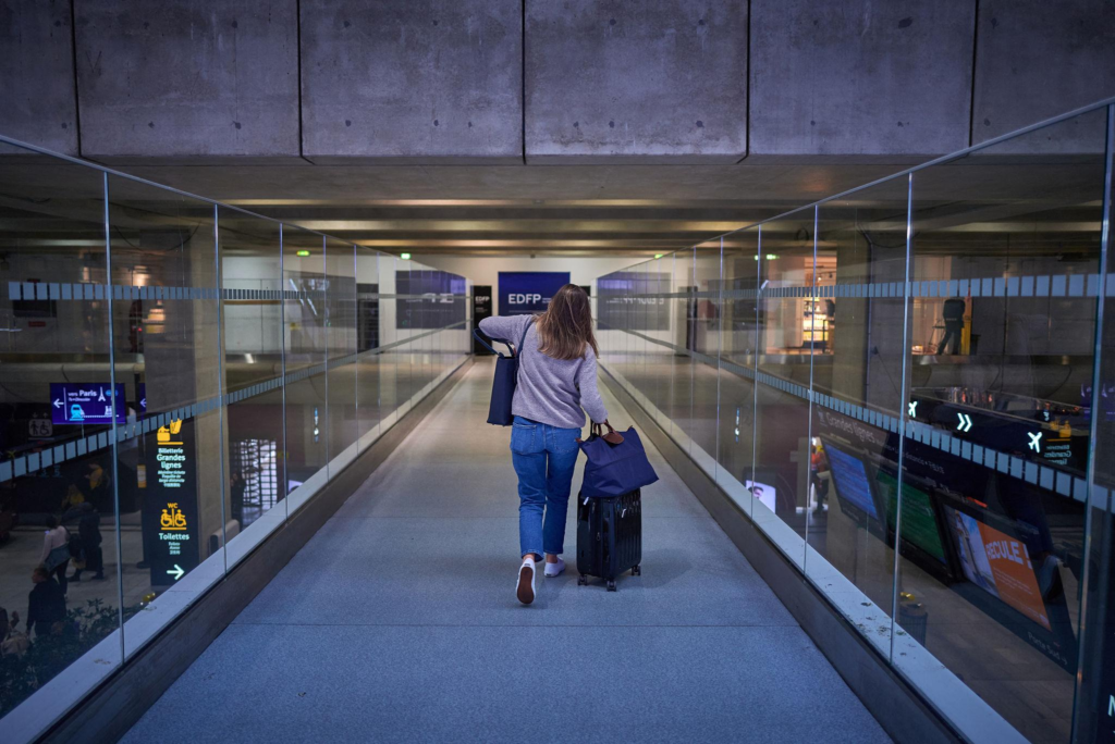 Traveler arriving at Charles de Gaulle Airport for Paris CDG taxi flat rate transfer